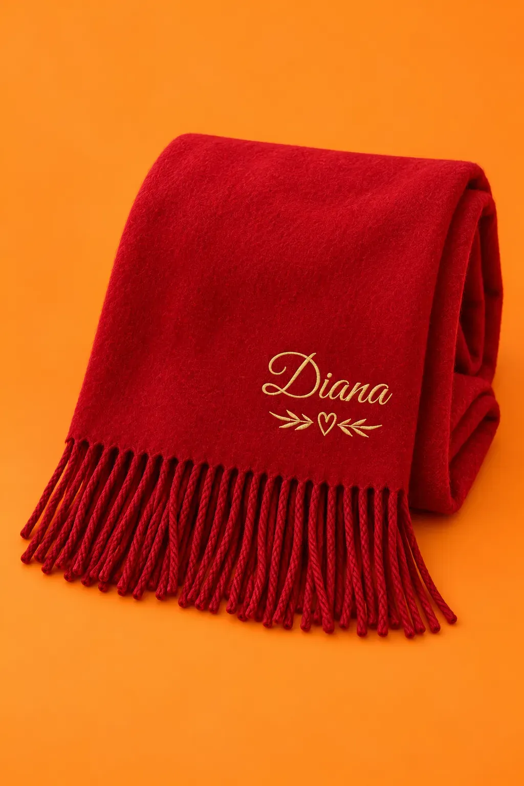 A cherry scarf with the name Diana in gold, on a tangerine background